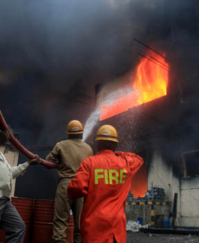 Firemen struggle for hours together to control the fire during a fire accident in Peenya in Bangalore on Friday. KPN